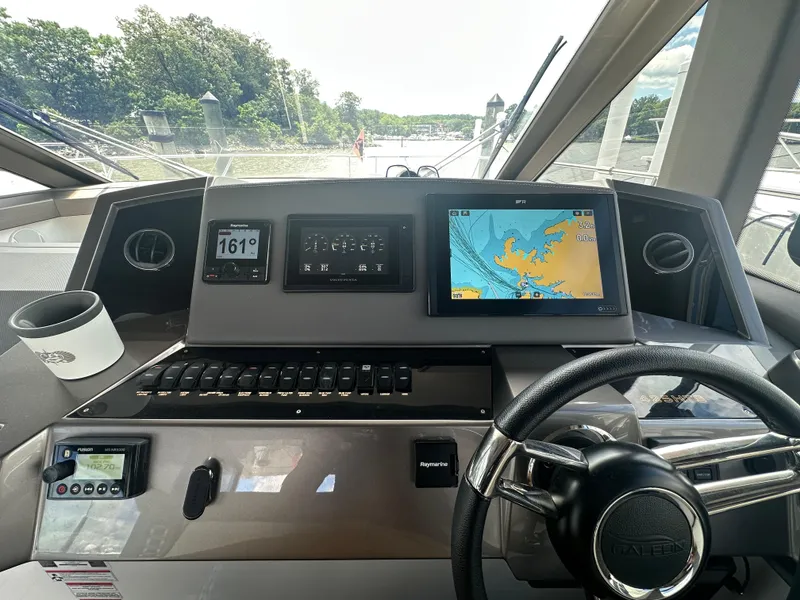 Slide: The Image of Helm of 2021 Galeon 425 HTS yacht with navigation screens and steering wheel. - 41
