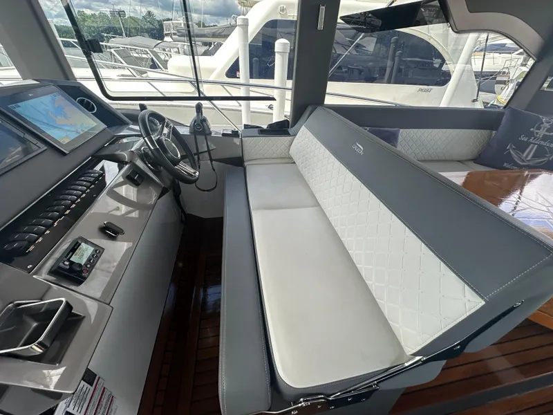 Slide: The Image of Interior of 2021 Galeon 425 HTS yacht with modern helm and seating area. - 43