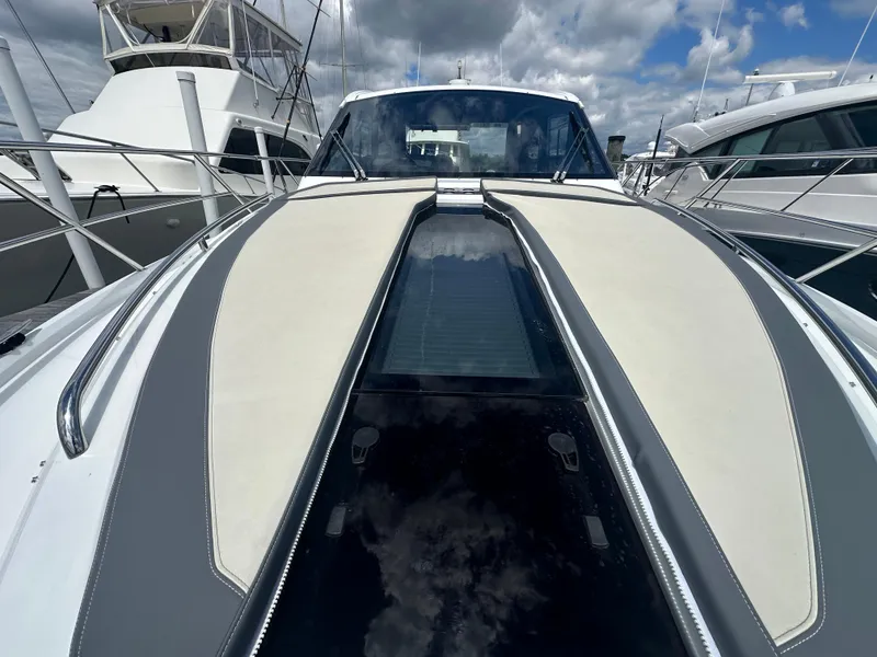 Slide: The Image of 2021 Galeon 425 HTS yacht with sleek design, docked under cloudy skies. - 47