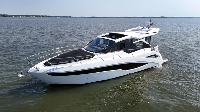 Slide: The Image of 2021 Galeon 425 HTS yacht cruising on calm waters. - 6