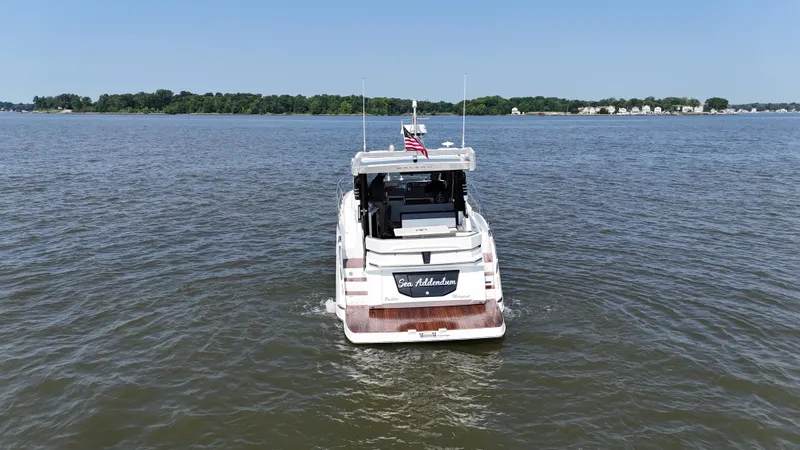 Slide: The Image of 2021 Galeon 425 HTS yacht cruising on a calm lake under a clear blue sky. - 9