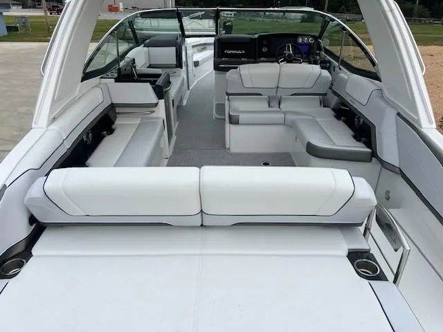 Slide: The Image of 2025 Formula 330 Crossover Bowrider I/O with spacious white seating and modern dashboard. - 6