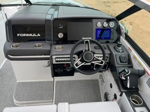 Slide: The Image of 2025 Formula 330 Crossover Bowrider I/O dashboard with steering wheel and control panel. - 7