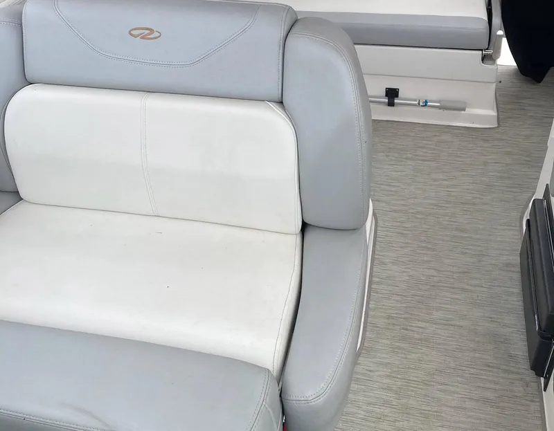 Slide: The Image of 2015 Regal 28 Express boat interior with gray and white seating. - 11