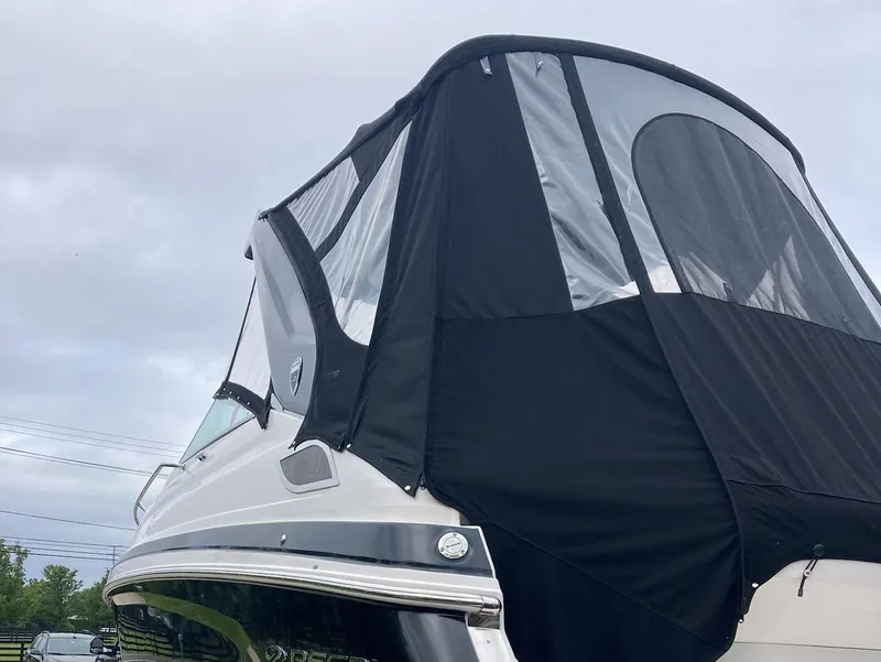 Slide: The Image of 2015 Regal 28 Express boat with black canopy against cloudy sky. - 14