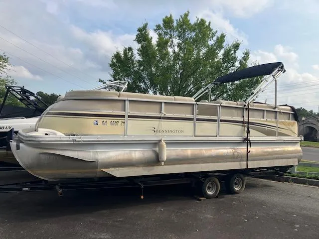 Slide: The Image of 2007 Bennington 2275QXi pontoon boat on trailer, parked outdoors. - 2