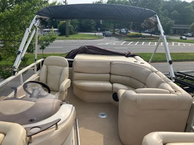 Slide: The Image of 2007 Bennington 2275QXi pontoon boat with beige seating and canopy, parked near a road. - 7