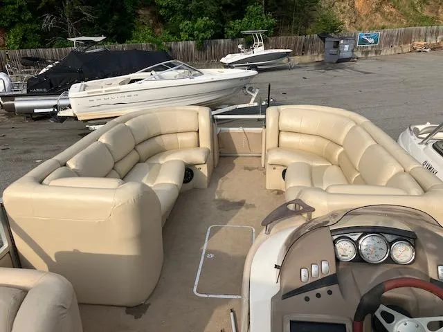 Slide: The Image of 2007 Bennington 2275QXi pontoon boat with beige seating, docked near other boats. - 8