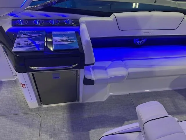 Slide: The Image of 2025 Formula 310 Bowrider I/O interior with blue LED lighting and luxurious seating. - 14