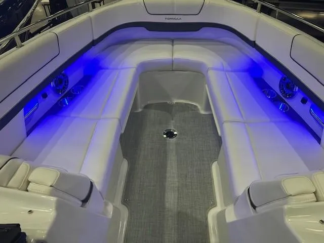 Slide: The Image of 2025 Formula 310 Bowrider I/O interior with blue LED lighting and spacious seating. - 15