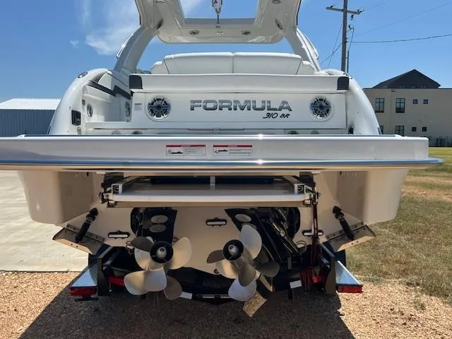 Slide: The Image of 2025 Formula 310 Bowrider I/O boat rear view with dual propellers and sleek design. - 3