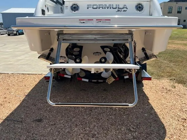 Slide: The Image of 2025 Formula 310 Bowrider I/O boat rear view with propellers and swim platform. - 5