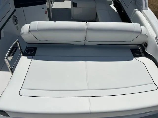 Slide: The Image of 2025 Formula 310 Bowrider I/O boat interior with white seating and cup holders. - 6