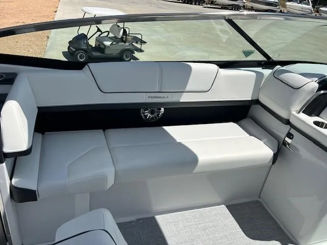 Slide: The Image of 2025 Formula 310 Bowrider I/O interior with white seating and sleek design. - 7