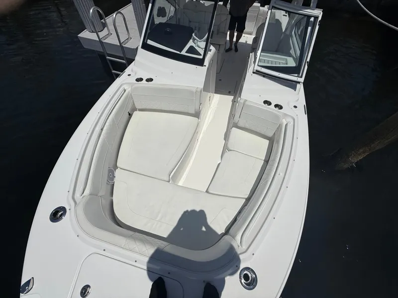 Slide: The Image of 2022 Edgewater 262 CX boat with spacious seating and open deck design. - 14