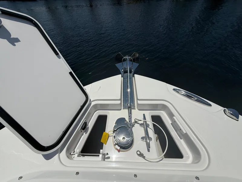 Slide: The Image of Open anchor compartment on 2022 Edgewater 262 CX boat, showing anchor and winch system. - 15