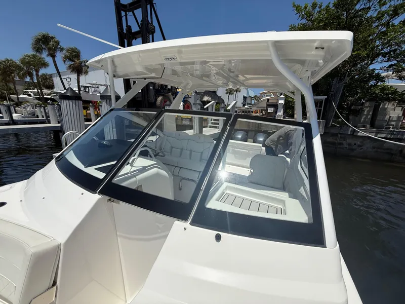 Slide: The Image of 2022 Edgewater 262 CX boat docked, showcasing sleek design and spacious interior. - 17