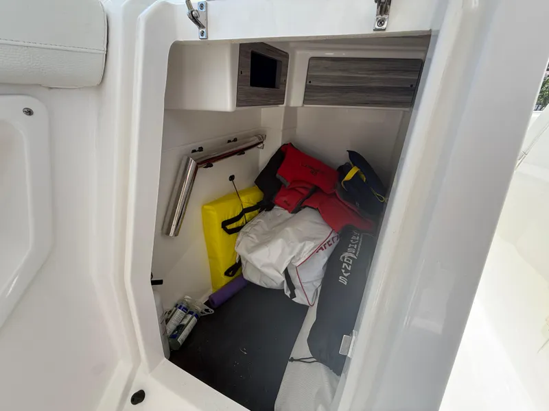 Slide: The Image of Storage compartment of 2022 Edgewater 262 CX boat with life jackets and gear. - 19