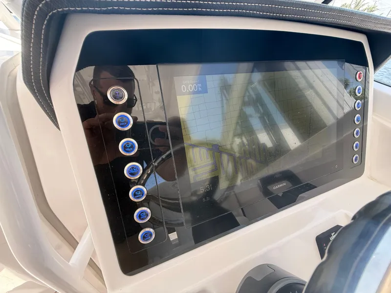 Slide: The Image of 2022 Edgewater 262 CX boat dashboard with touchscreen display and control buttons. - 24