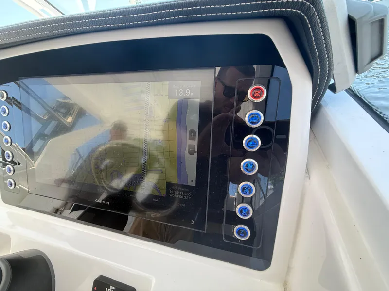 Slide: The Image of 2022 Edgewater 262 CX boat dashboard with touchscreen and control buttons. - 25