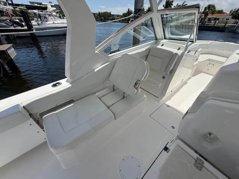 Slide: The Image of 2022 Edgewater 262 CX boat interior with white seating and sleek design. - 30