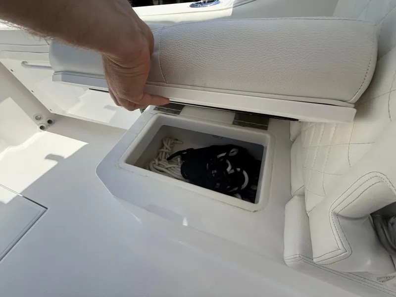 Slide: The Image of 2022 Edgewater 262 CX boat seat storage compartment with ropes inside. - 32