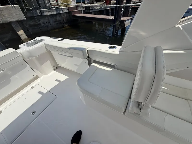 Slide: The Image of 2022 Edgewater 262 CX boat interior with white seating and deck. - 33