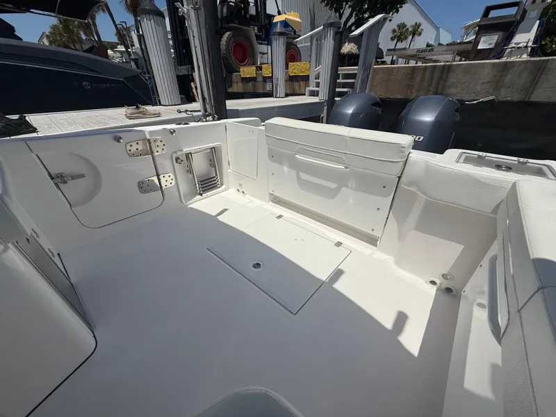 Slide: The Image of 2022 Edgewater 262 CX boat interior with seating and storage compartments. - 37