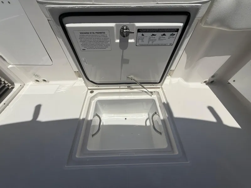 Slide: The Image of Open storage compartment on 2022 Edgewater 262 CX boat. - 38