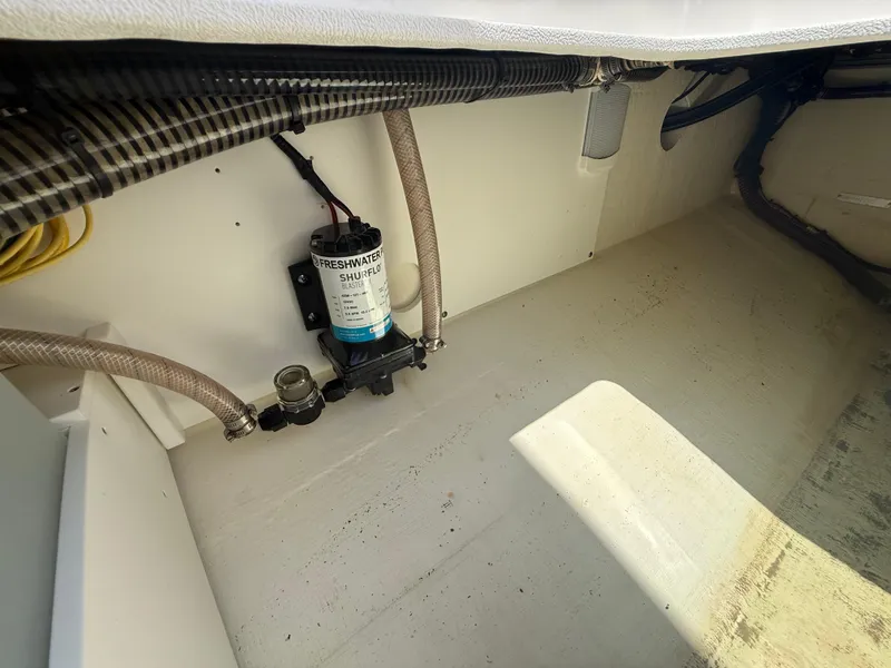 Slide: The Image of 2022 Edgewater 262 CX boat interior showing plumbing and wiring components. - 40