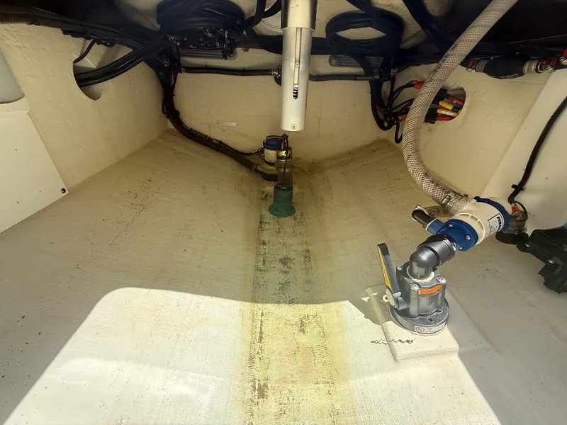 Slide: The Image of Interior view of 2022 Edgewater 262 CX boat showing bilge area and plumbing components. - 41