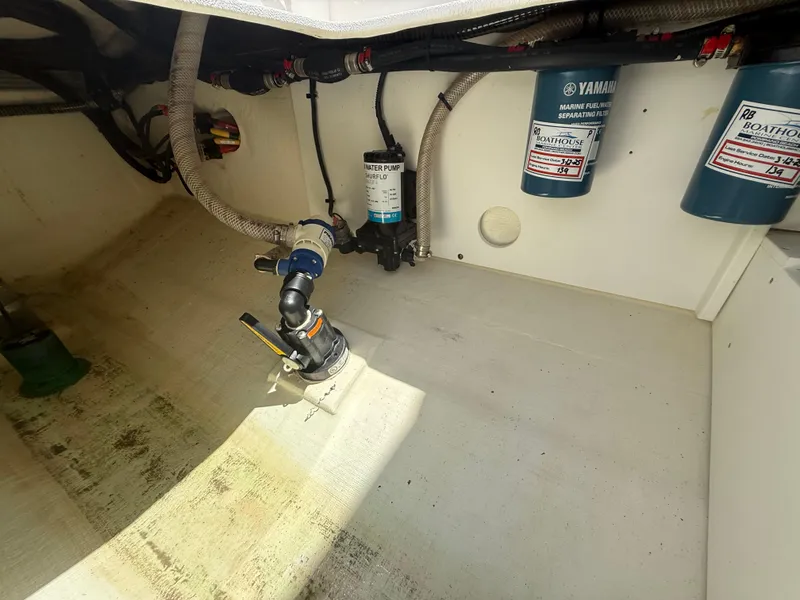 Slide: The Image of Interior view of 2022 Edgewater 262 CX boat showing engine components and filters. - 42