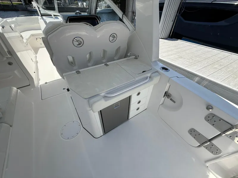 Slide: The Image of 2022 Edgewater 262 CX boat interior with seating and storage compartments. - 43