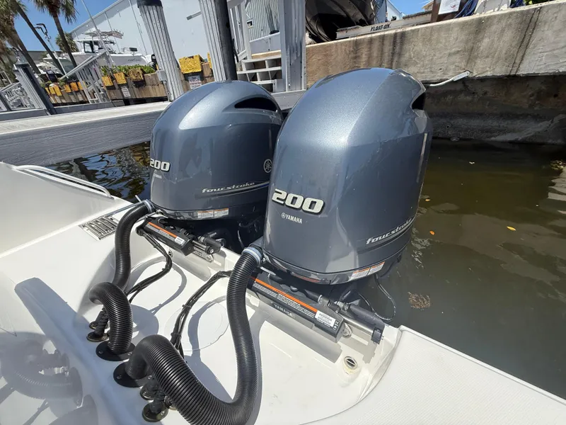 Slide: The Image of Twin Yamaha 200 outboard engines on a 2022 Edgewater 262 CX boat at a dock. - 48