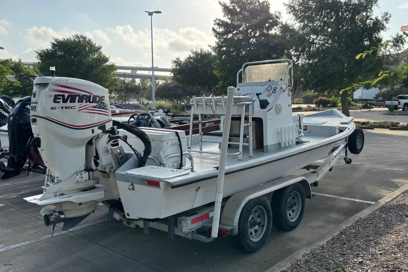 Slide: The Image of Boat on trailer with Evinrude engine, Destiny model, parked outdoors, 2001. - 6