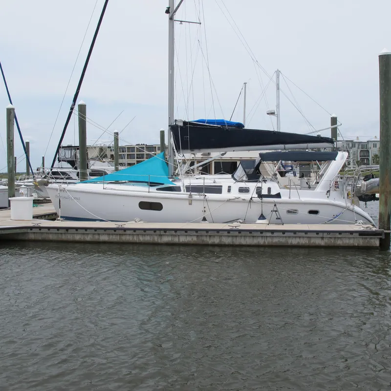 The Image of 1998 Hunter 410 sailboat docked at marina, featuring sleek design and white hull. - 0