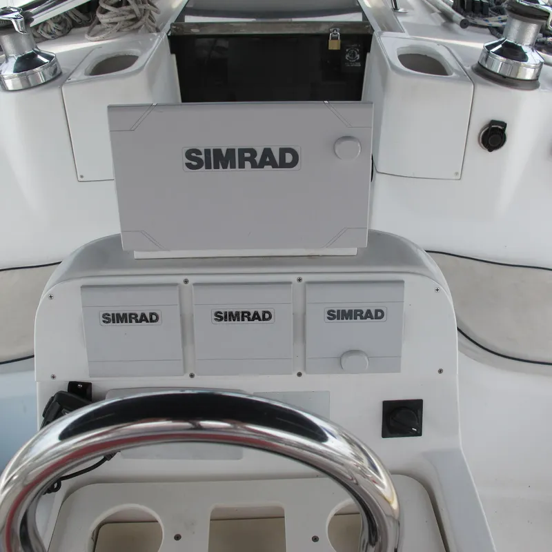 Slide: The Image of Steering console of a 1998 Hunter 410 sailboat with Simrad navigation equipment. - 11