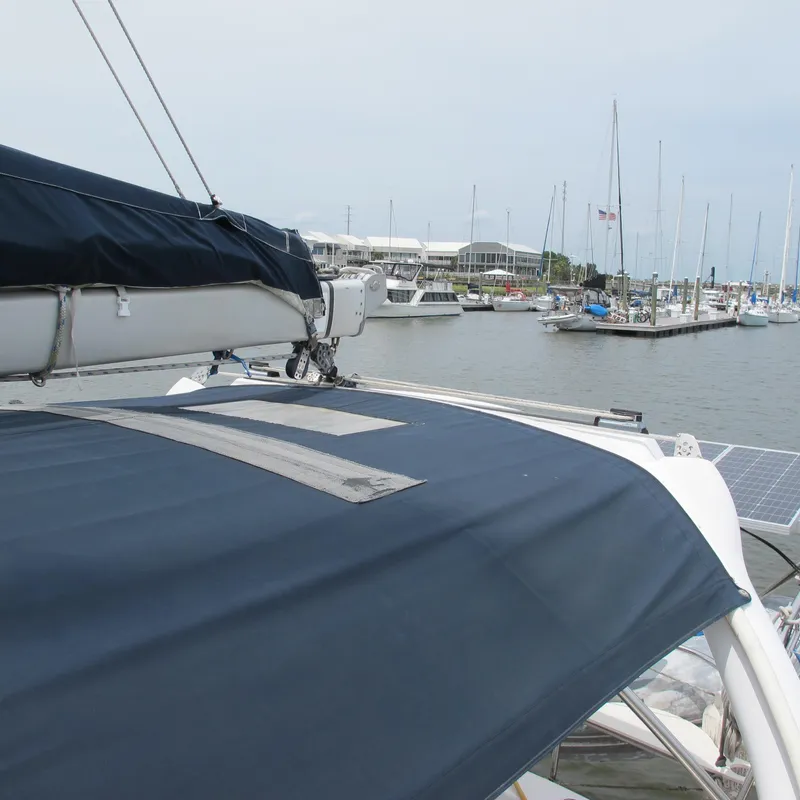 Slide: The Image of Sailboat in marina, Hunter 410 model, 1998, with covered deck and visible masts. - 12