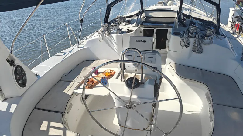 Slide: The Image of Cockpit of a 1998 Hunter 410 sailboat with steering wheel and navigation equipment. - 13