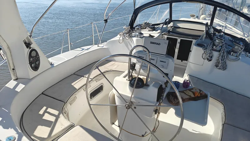 Slide: The Image of Sailboat cockpit of 1998 Hunter 410 with steering wheel and navigation equipment. - 14