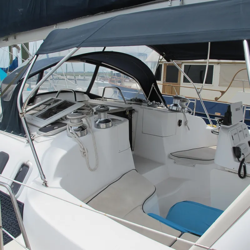 Slide: The Image of 1998 Hunter 410 sailboat cockpit with canopy and seating. - 15