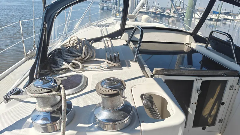 Slide: The Image of 1998 Hunter 410 sailboat deck with winches and ropes, docked at marina. - 16