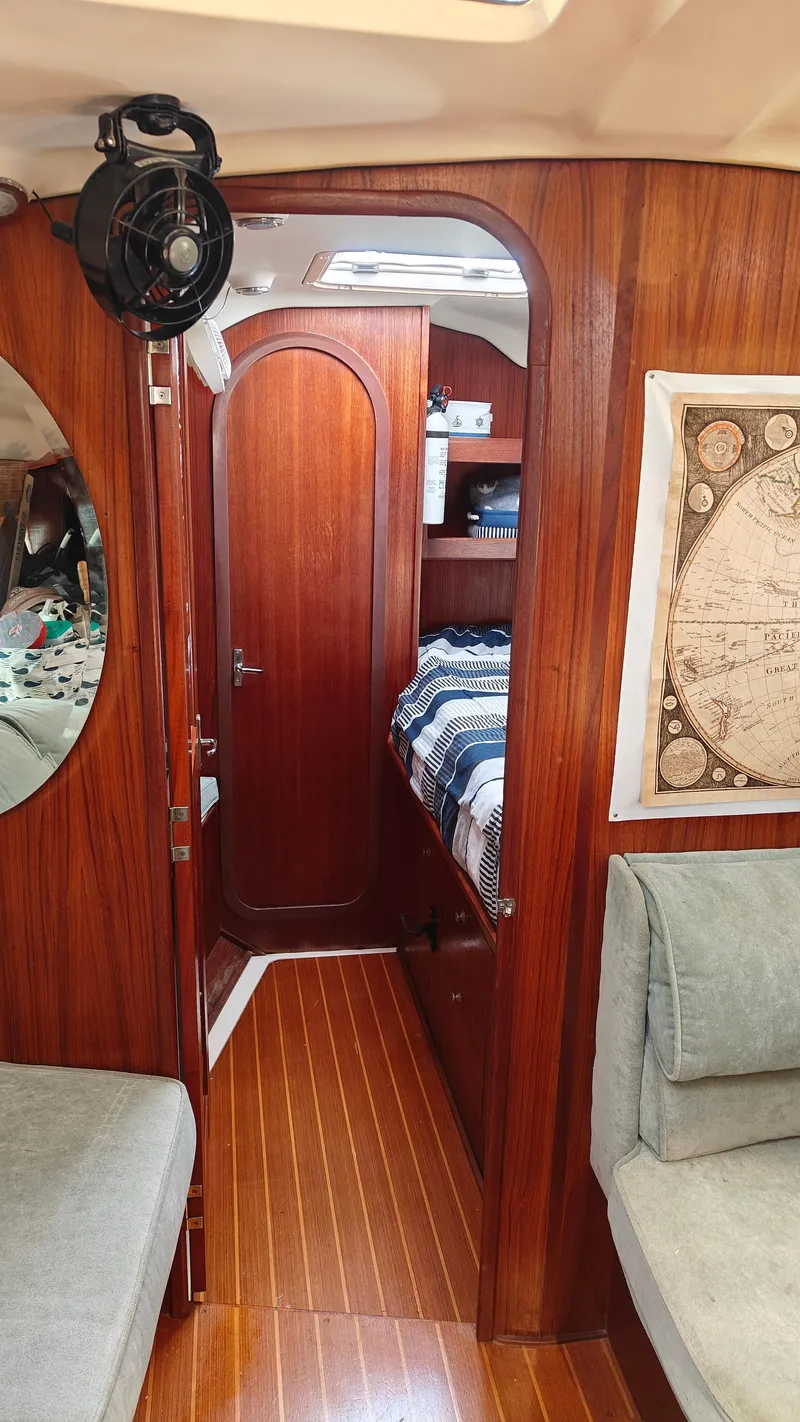 Slide: The Image of Interior of 1998 Hunter 410 sailboat with wooden finish and cozy cabin. - 24