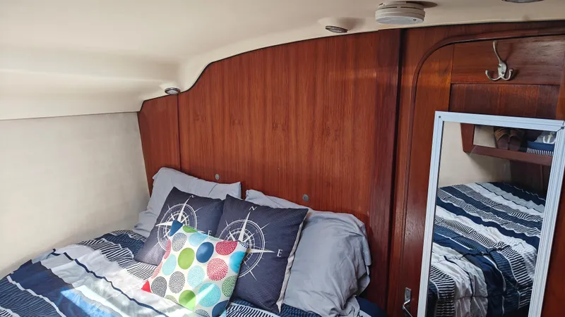 Slide: The Image of Cozy cabin interior of 1998 Hunter 410 sailboat with nautical-themed bedding. - 28