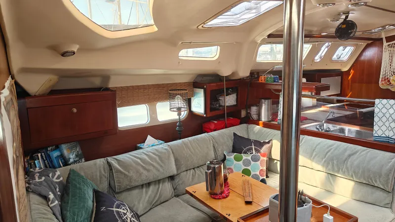 Slide: The Image of Cozy interior of a 1998 Hunter 410 sailboat with comfortable seating and natural light. - 32