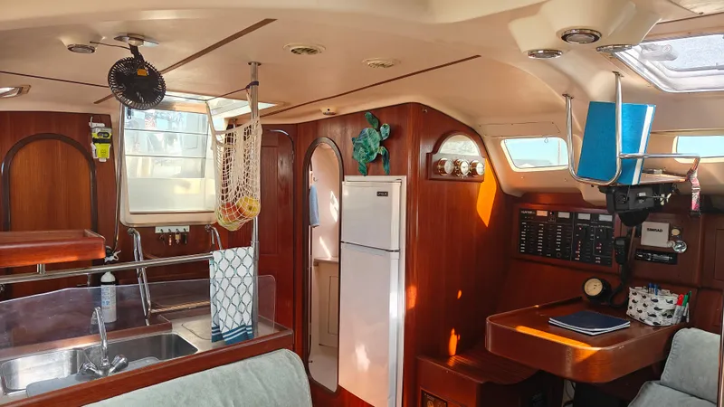 Slide: The Image of Interior of a 1998 Hunter 410 sailboat with wood finish and modern amenities. - 33
