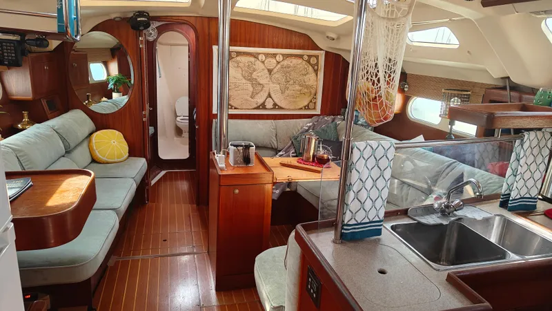 Slide: The Image of Interior of 1998 Hunter 410 sailboat with cozy seating and wooden finishes. - 36