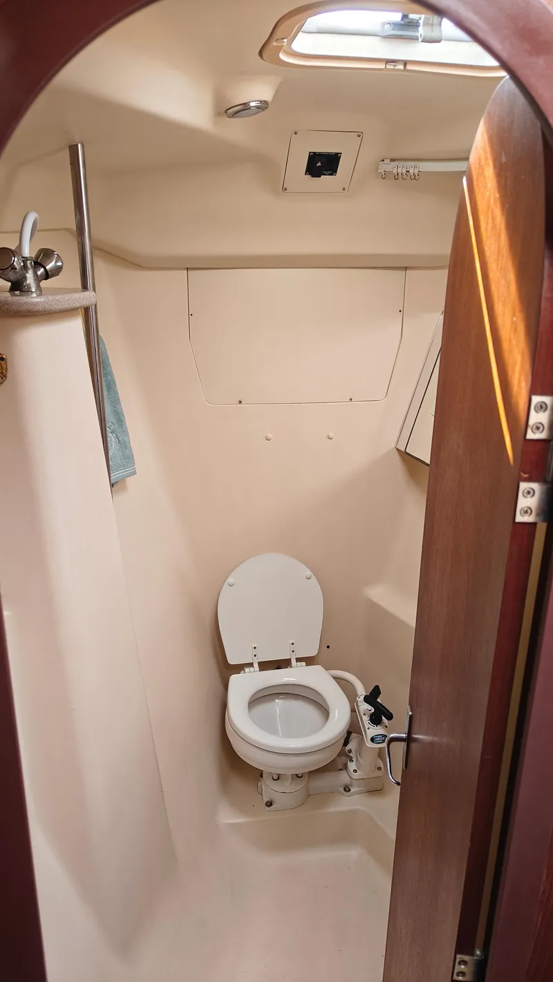Slide: The Image of 1998 Hunter 410 sailboat bathroom with toilet and shower. - 41