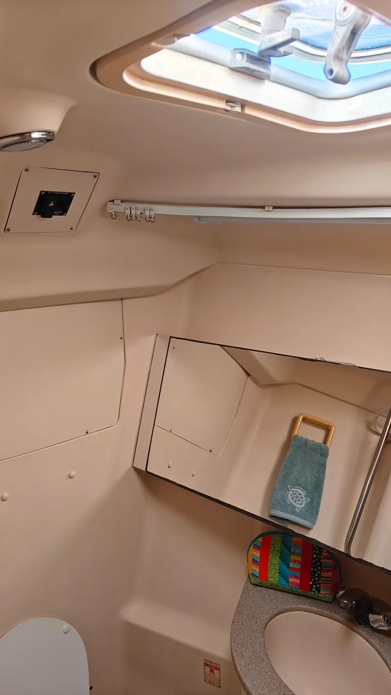 Slide: The Image of Interior of a 1998 Hunter 410 boat bathroom with skylight and mirror. - 42