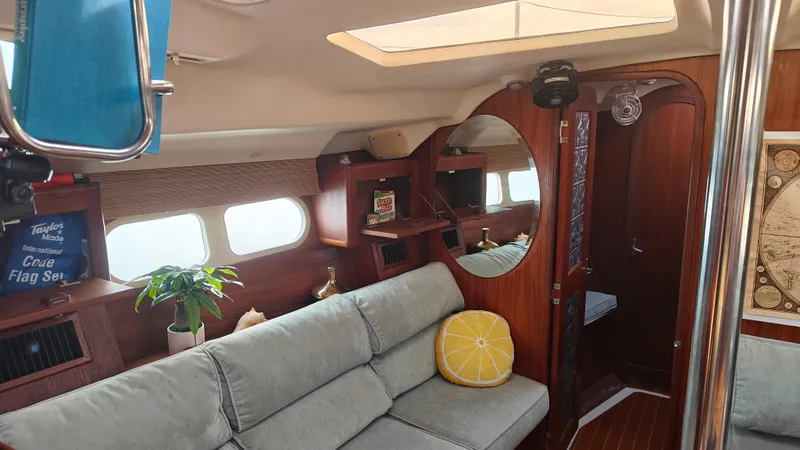 Slide: The Image of Interior of a 1998 Hunter 410 sailboat with cozy seating and wooden accents. - 43